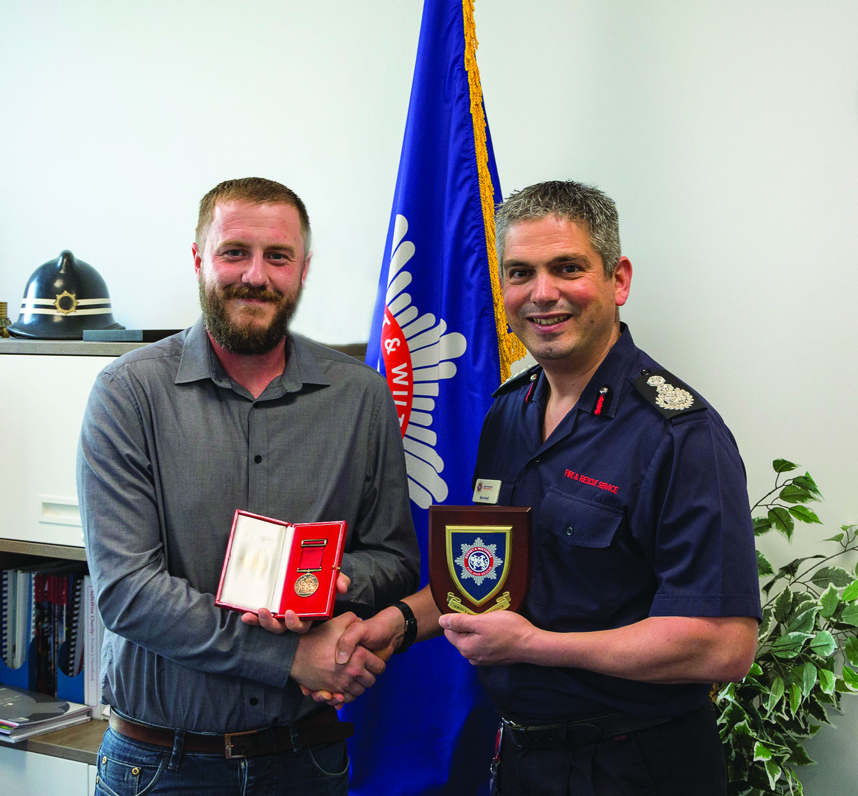 Luke Ridley receives Society for the Protection of Life from Fire medal from Chief Fire Officer Ben Ansell