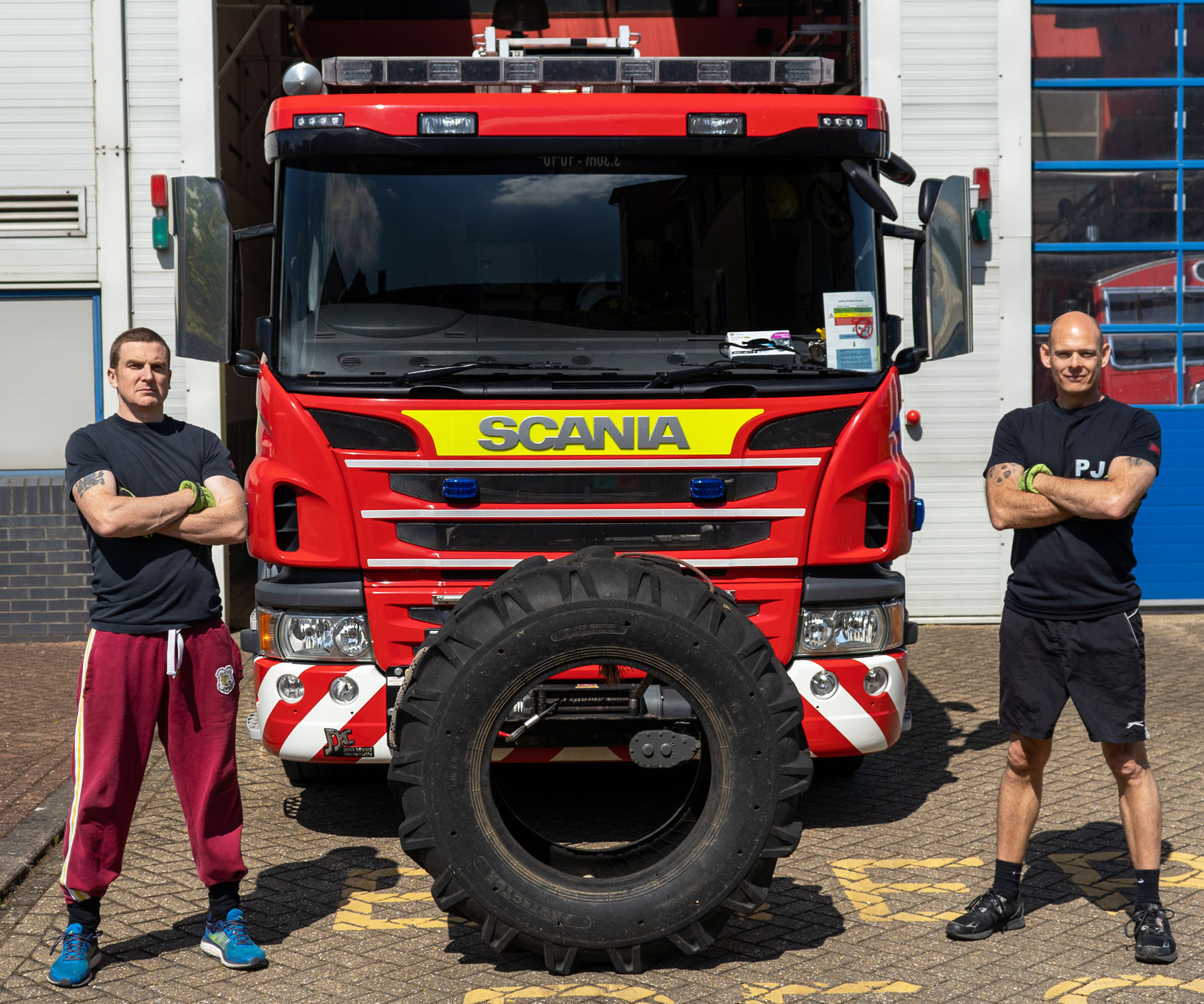 Westlea firefighters Alex Davidson and Paul Jarmey are pictured with the lorry tyre they are flipping for charity