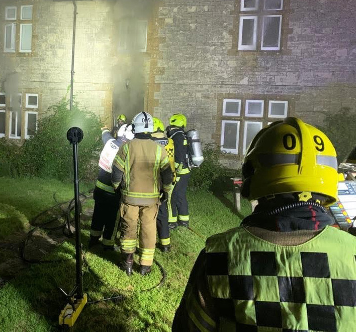 Firefighters outside of the property on fire