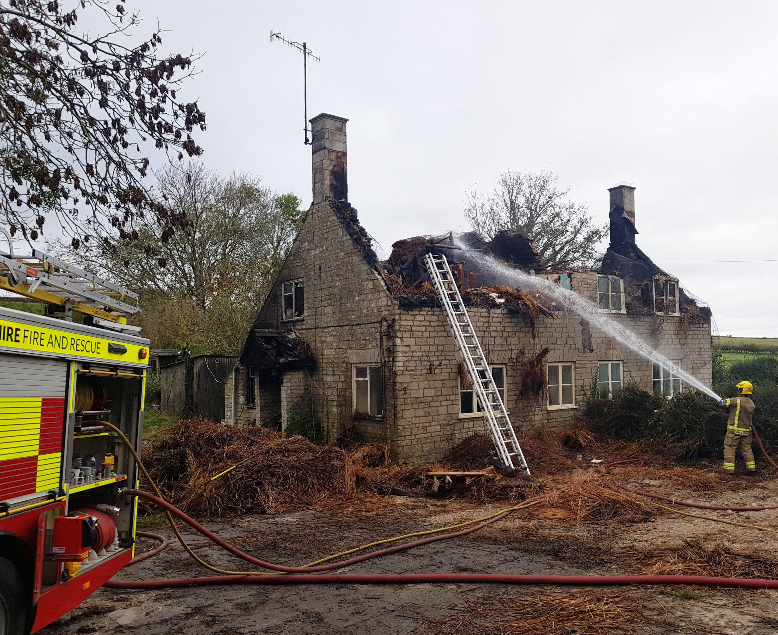 Shot of cottages after fire destroys thatched roof