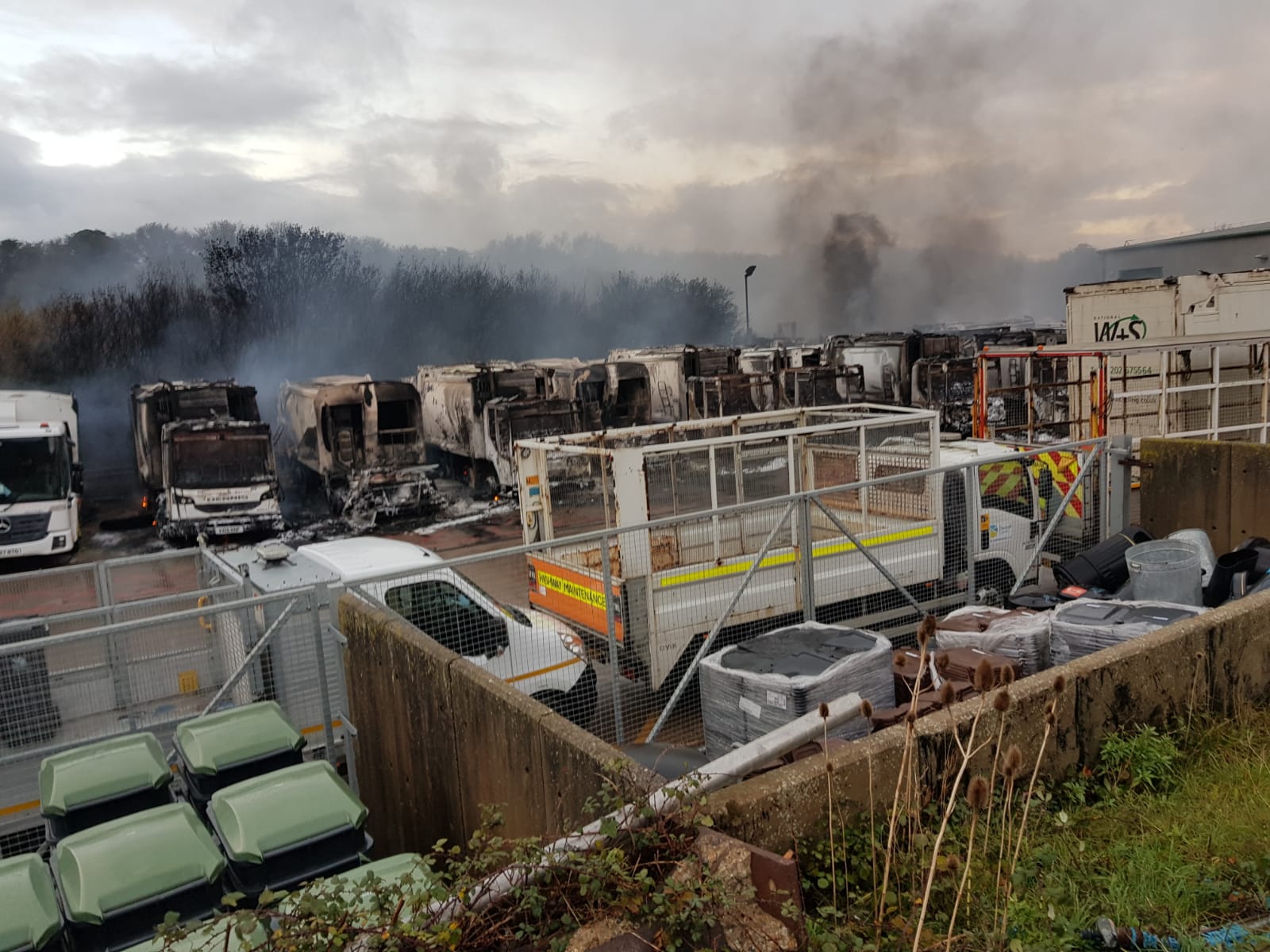 Shot of Chickerell depot and multiple vehicles destroyed by fire
