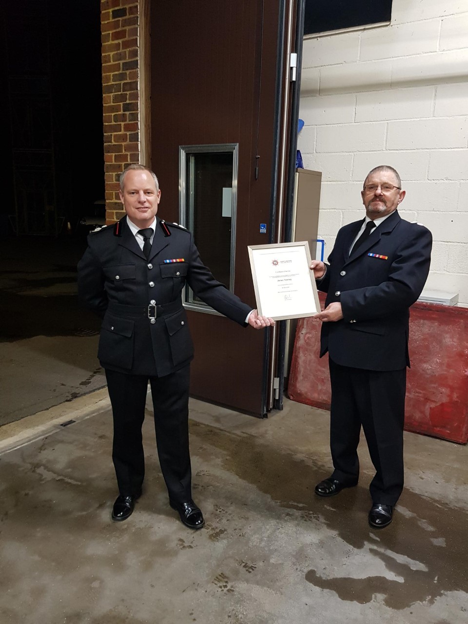 Assistant Chief Fire Officer, Byron Standen presents Watch Manager Jim Twomey with this leaving certificate at Jim's retirement presentation evening