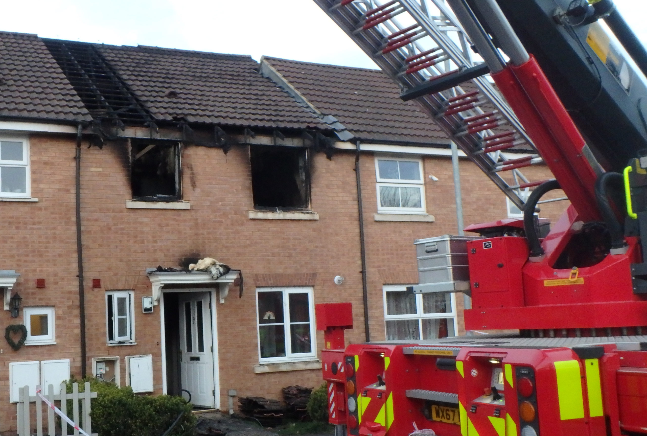 Front of Devizes house damaged by fire, with fire appliance on view