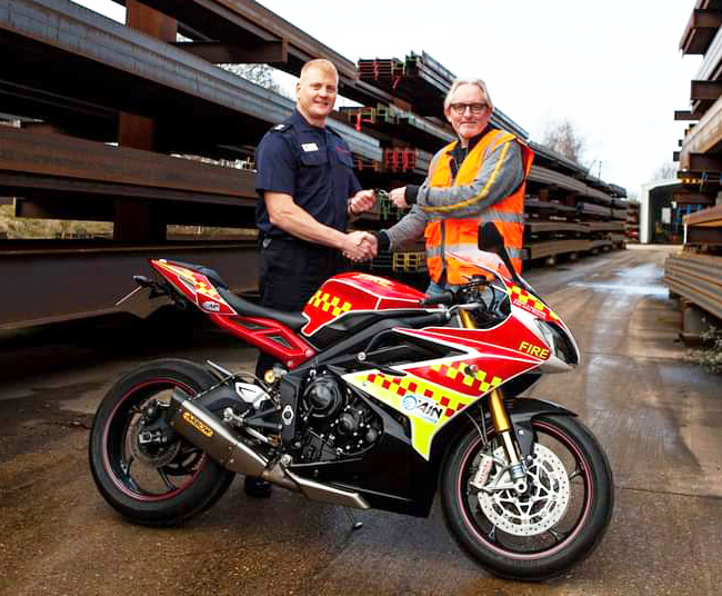 Watch Manager Dean Hoskins and Alan Boyden of AJN Steelstock are pictured with the fire bike funded by the company’s sponsorship.