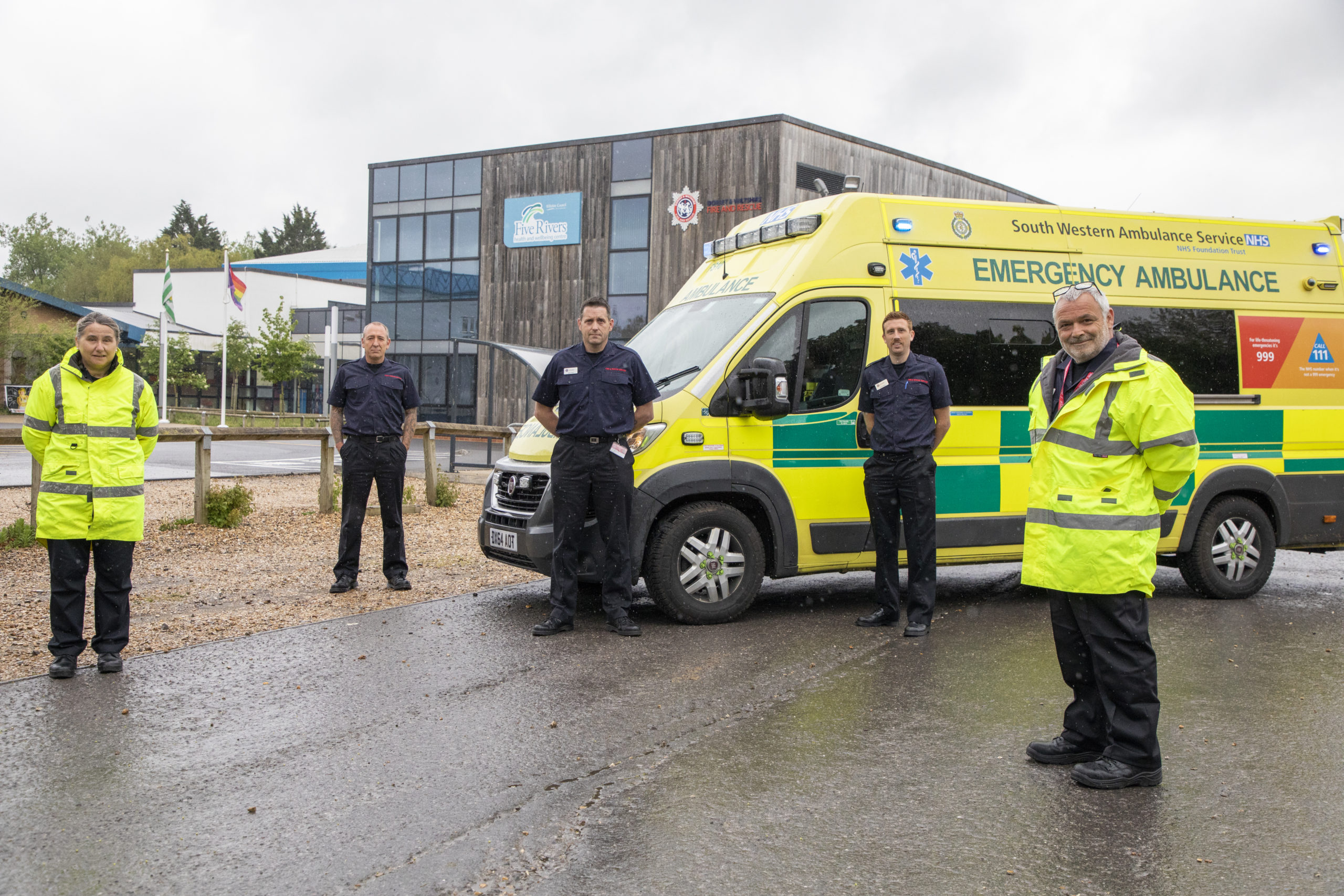 Firefighters and Ambulance service staff stood with an ambulance